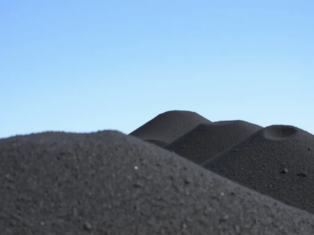 Piles of asphalt feedstock material used in road construction
